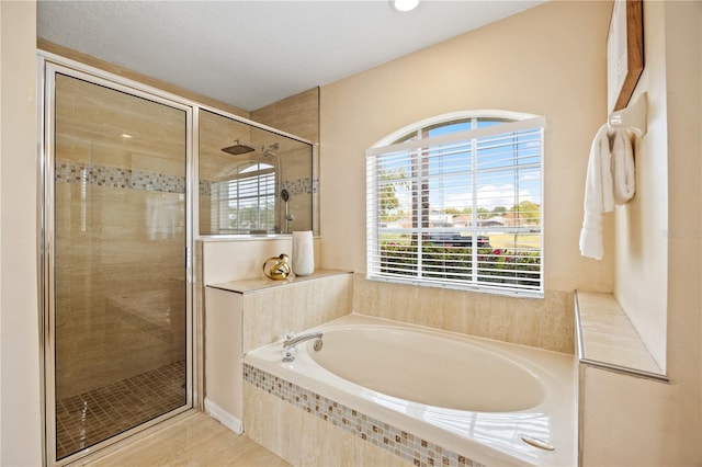 bathroom featuring separate shower and tub