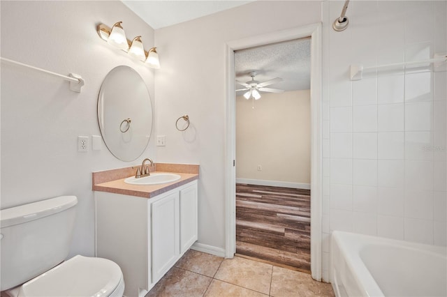 bathroom featuring toilet, a textured ceiling, vanity, ceiling fan, and tile patterned flooring