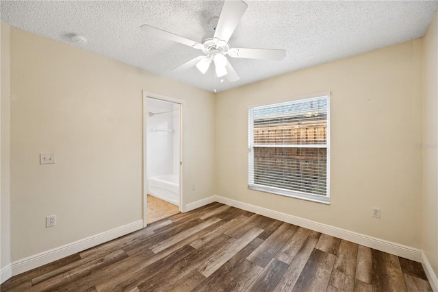 spare room with ceiling fan, wood-type flooring, and a textured ceiling