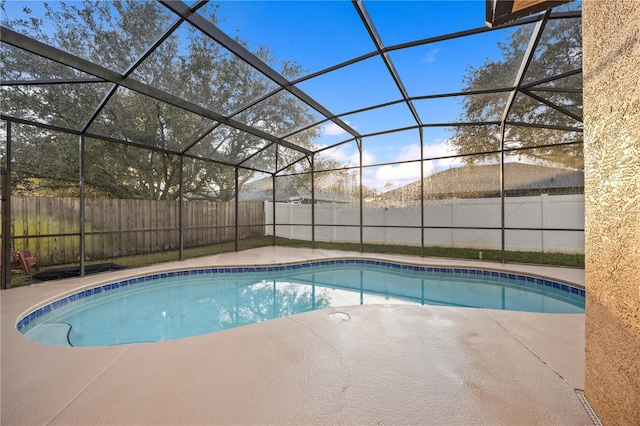 view of pool featuring a patio and glass enclosure