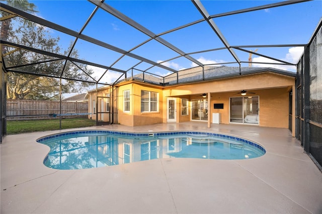 view of pool featuring ceiling fan, glass enclosure, and a patio area