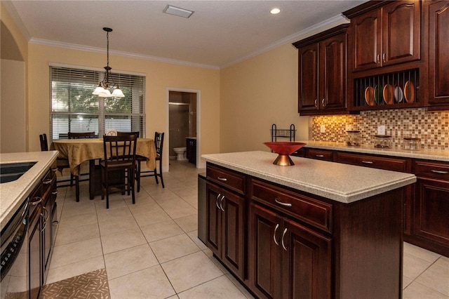 kitchen featuring crown molding, an inviting chandelier, tasteful backsplash, light tile patterned floors, and pendant lighting