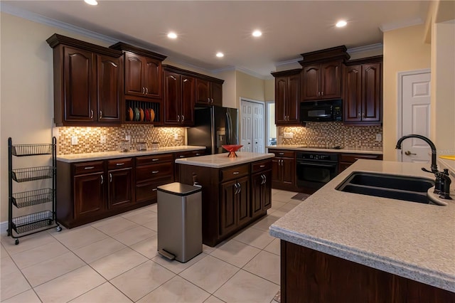 kitchen featuring sink, crown molding, dark brown cabinets, a kitchen island, and black appliances