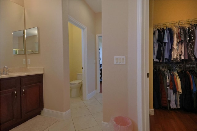 bathroom with vanity, tile patterned floors, and toilet