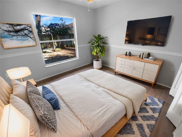 bedroom featuring dark wood-style floors and baseboards