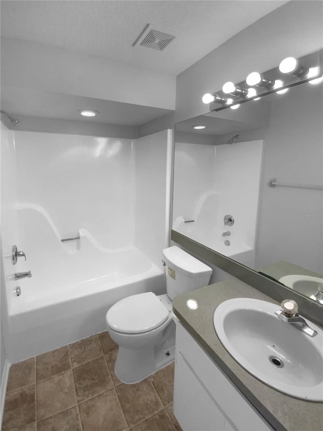 full bathroom featuring visible vents, toilet, tub / shower combination, a textured ceiling, and vanity