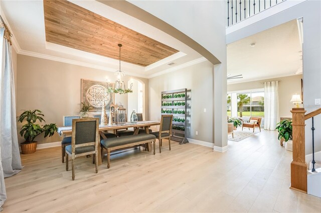 7515 John Hancock Dr, Winter Garden, FL 34787 - dining space with a tray ceiling, light wood-style flooring, a chandelier, wooden ceiling, and baseboards