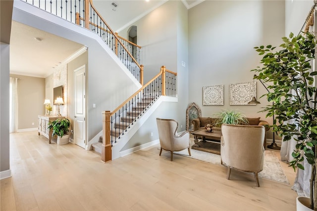 7515 John Hancock Dr, Winter Garden, FL 34787 - stairway with ornamental molding, wood finished floors, and a towering ceiling
