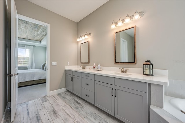 7515 John Hancock Dr, Winter Garden, FL 34787 - bathroom with wood finished floors, double vanity, a sink, and connected bathroom