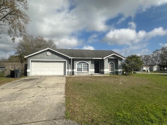 ranch-style house with a garage, fence, concrete driveway, stucco siding, and a front yard