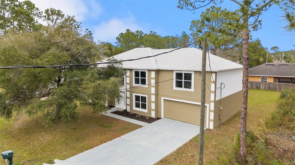 210 Underwood Trl, Palm Coast, FL 32164 - view of front of property featuring stucco siding, concrete driveway, fence, a garage, and a front lawn