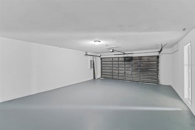 garage with electric panel and a garage door opener