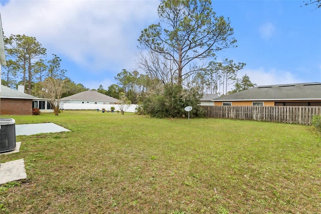 view of yard featuring central AC, a patio area, and a fenced backyard