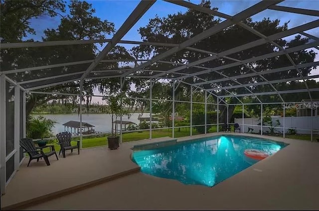 view of pool featuring a fenced in pool, glass enclosure, a water view, and a patio