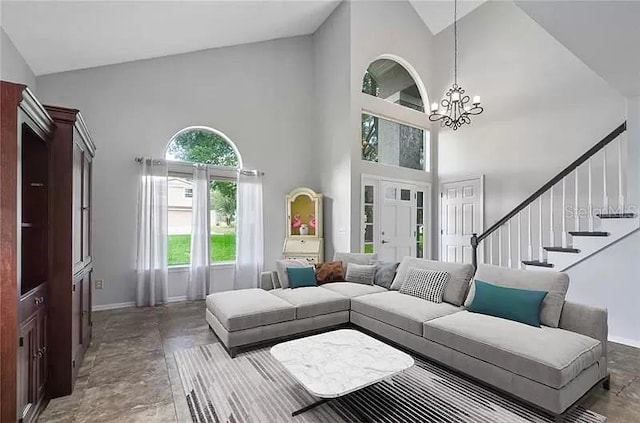 living area featuring a chandelier, high vaulted ceiling, stairway, and baseboards