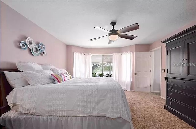 bedroom featuring light carpet, access to exterior, baseboards, and a ceiling fan