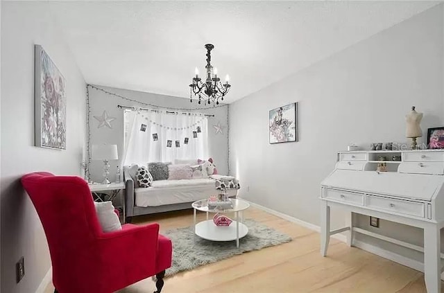 bedroom with baseboards, a chandelier, and wood finished floors