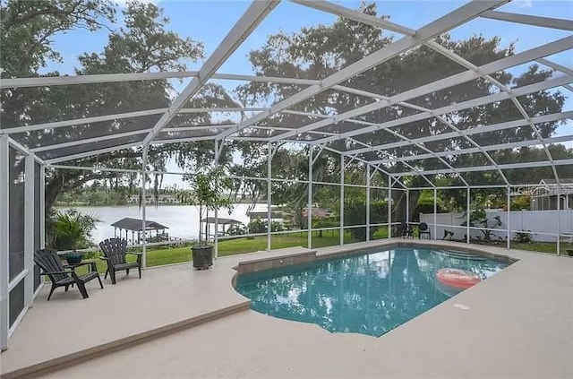 view of swimming pool featuring a fenced in pool, a patio, a water view, fence, and a lanai