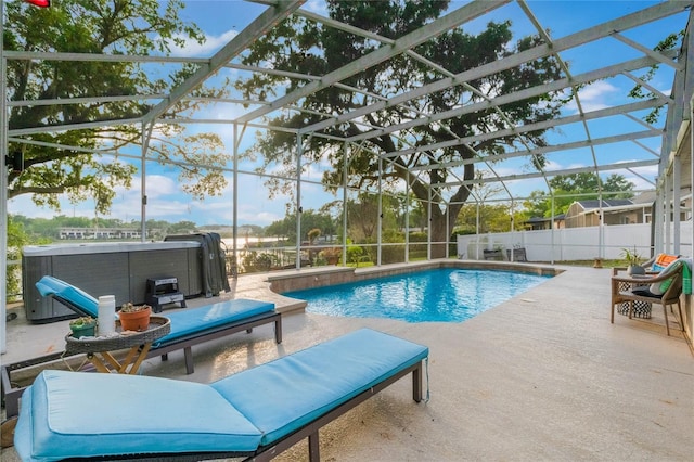 view of swimming pool featuring fence, a lanai, a fenced in pool, a hot tub, and a patio area