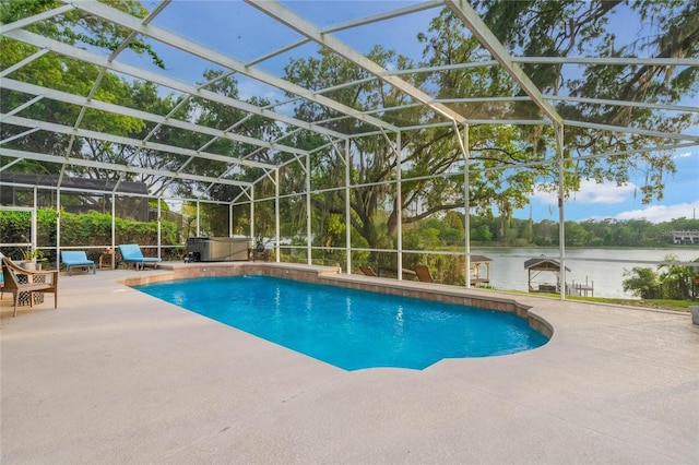 outdoor pool featuring glass enclosure, a water view, a patio, and a hot tub