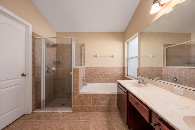 full bathroom featuring tile patterned flooring, a sink, a bath, double vanity, and a stall shower