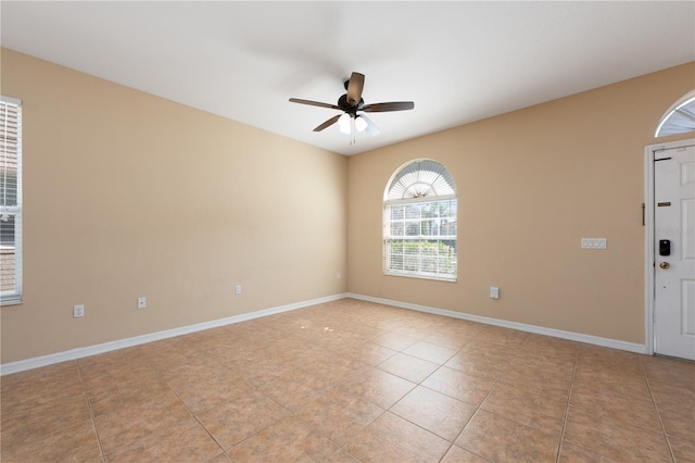 unfurnished room featuring baseboards, a ceiling fan, and light tile patterned flooring