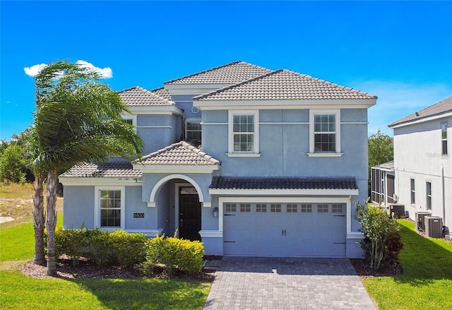 mediterranean / spanish-style home with a garage and central AC