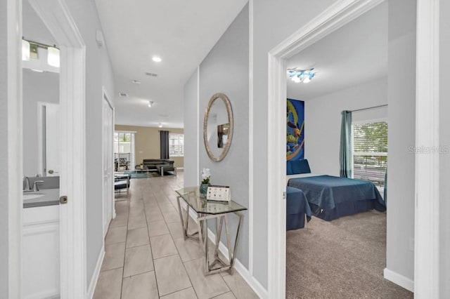 9017 Dogleg Dr, Davenport, FL 33896 - corridor featuring light tile patterned floors, baseboards, and light carpet