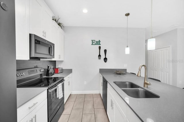 9017 Dogleg Dr, Davenport, FL 33896 - kitchen featuring electric range, a sink, decorative backsplash, white cabinetry, and stainless steel microwave