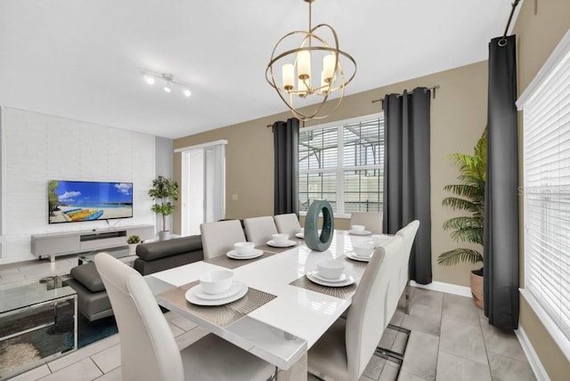 9017 Dogleg Dr, Davenport, FL 33896 - dining room with baseboards, an inviting chandelier, and light tile patterned flooring