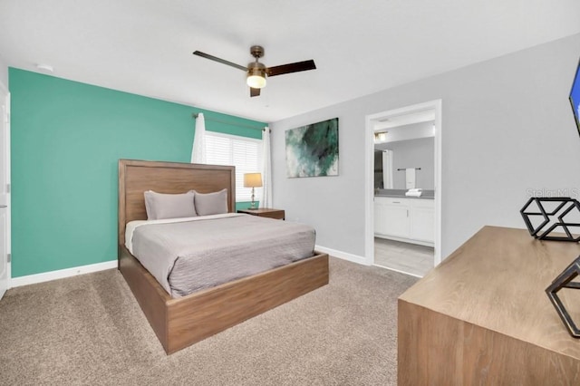 9017 Dogleg Dr, Davenport, FL 33896 - bedroom with light colored carpet, ensuite bath, baseboards, and ceiling fan