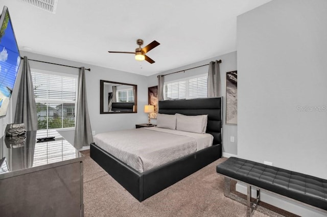 9017 Dogleg Dr, Davenport, FL 33896 - carpeted bedroom with baseboards, visible vents, and ceiling fan