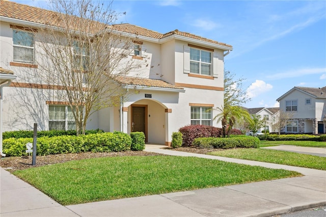 9017 Dogleg Dr, Davenport, FL 33896 - view of front facade with stucco siding, a tiled roof, and a front yard