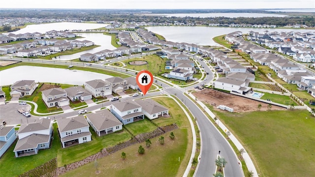 bird's eye view featuring a water view and a residential view