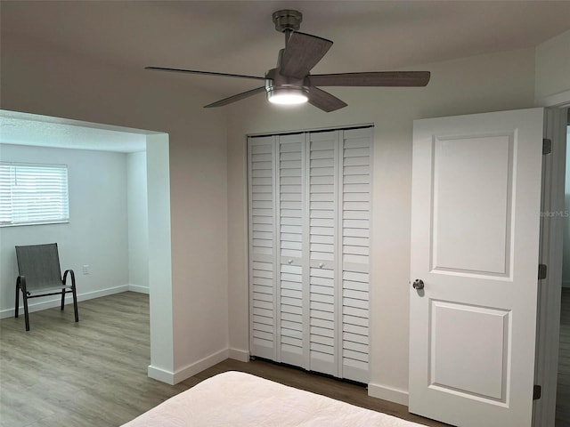 bedroom featuring hardwood / wood-style floors, ceiling fan, and a closet