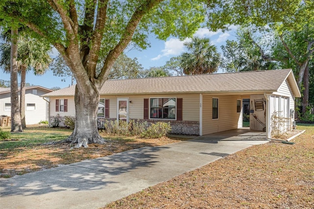 ranch-style home with concrete driveway and brick siding