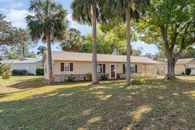 ranch-style home featuring brick siding and a front yard