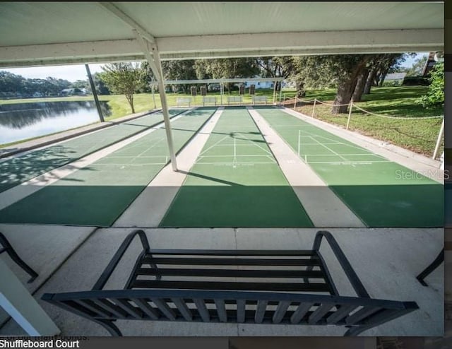 surrounding community featuring a water view and shuffleboard