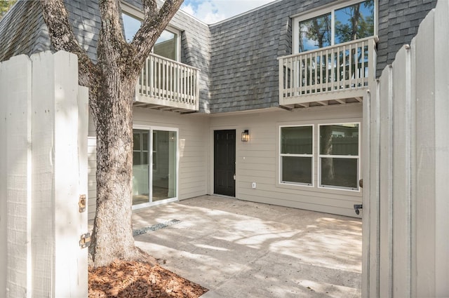 back of house with a patio and a balcony