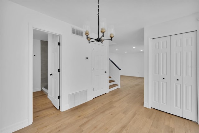 dining space featuring a notable chandelier and light wood-type flooring