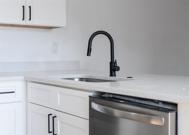 room details featuring white cabinetry, dishwasher, and sink