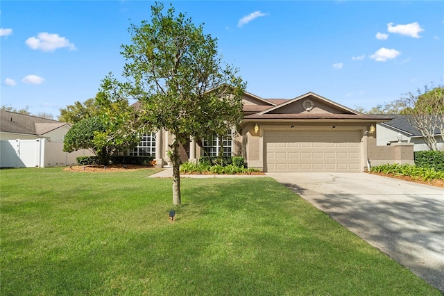 view of front of house featuring stucco siding, fence, a garage, driveway, and a front lawn