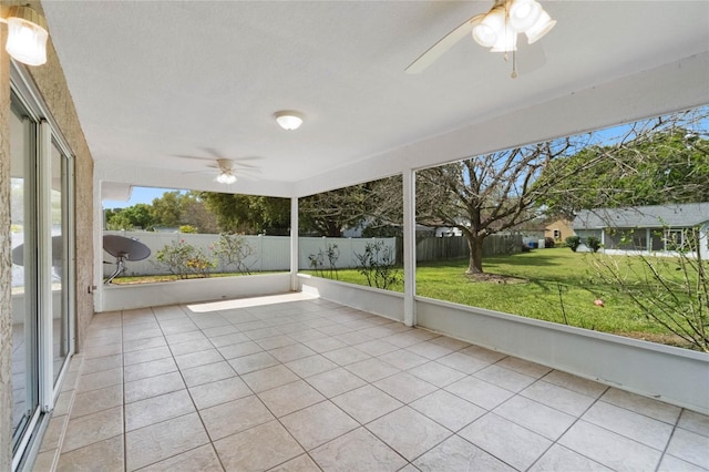 unfurnished sunroom with a ceiling fan