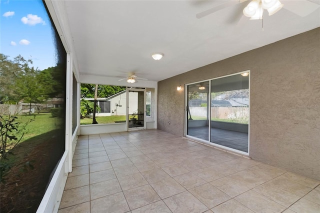 unfurnished sunroom with ceiling fan and a wealth of natural light