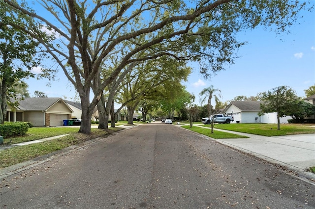 view of road featuring curbs, sidewalks, and a residential view