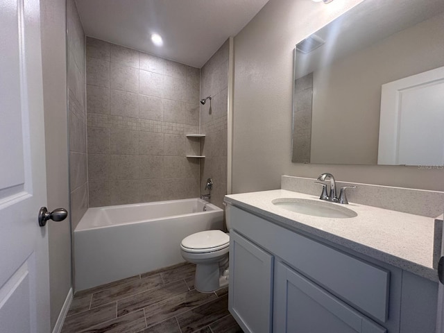 full bathroom featuring vanity, toilet, and tiled shower / bath combo