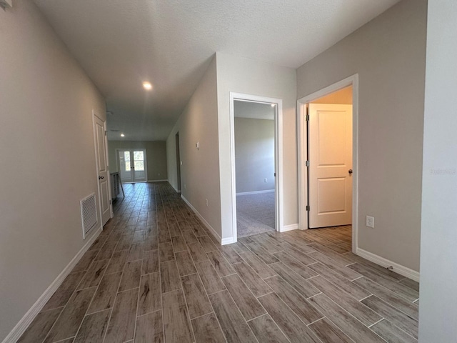 corridor with a textured ceiling