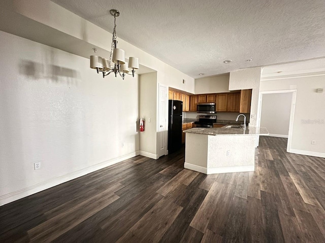 kitchen featuring pendant lighting, sink, dark wood-type flooring, stainless steel appliances, and a chandelier