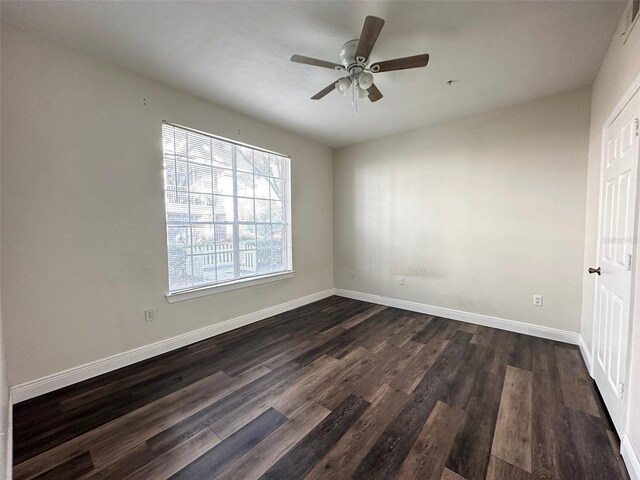 empty room featuring ceiling fan and dark hardwood / wood-style floors