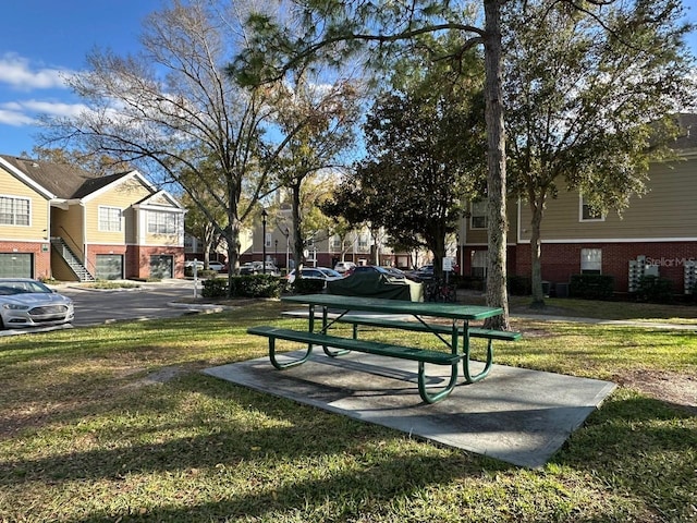 view of property's community with a lawn